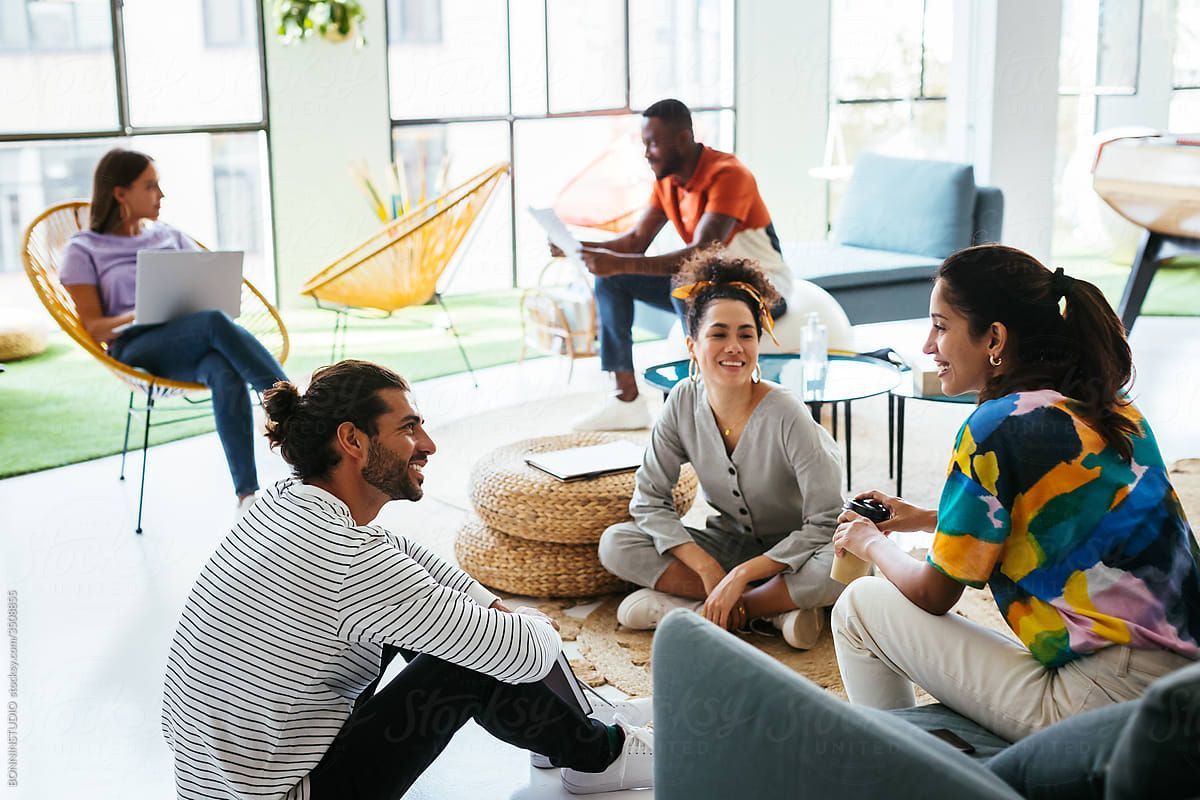 A group of people are sitting on the floor in a room.