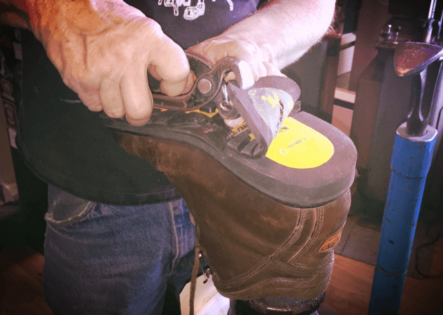 Man applying gum to the shoe sole
