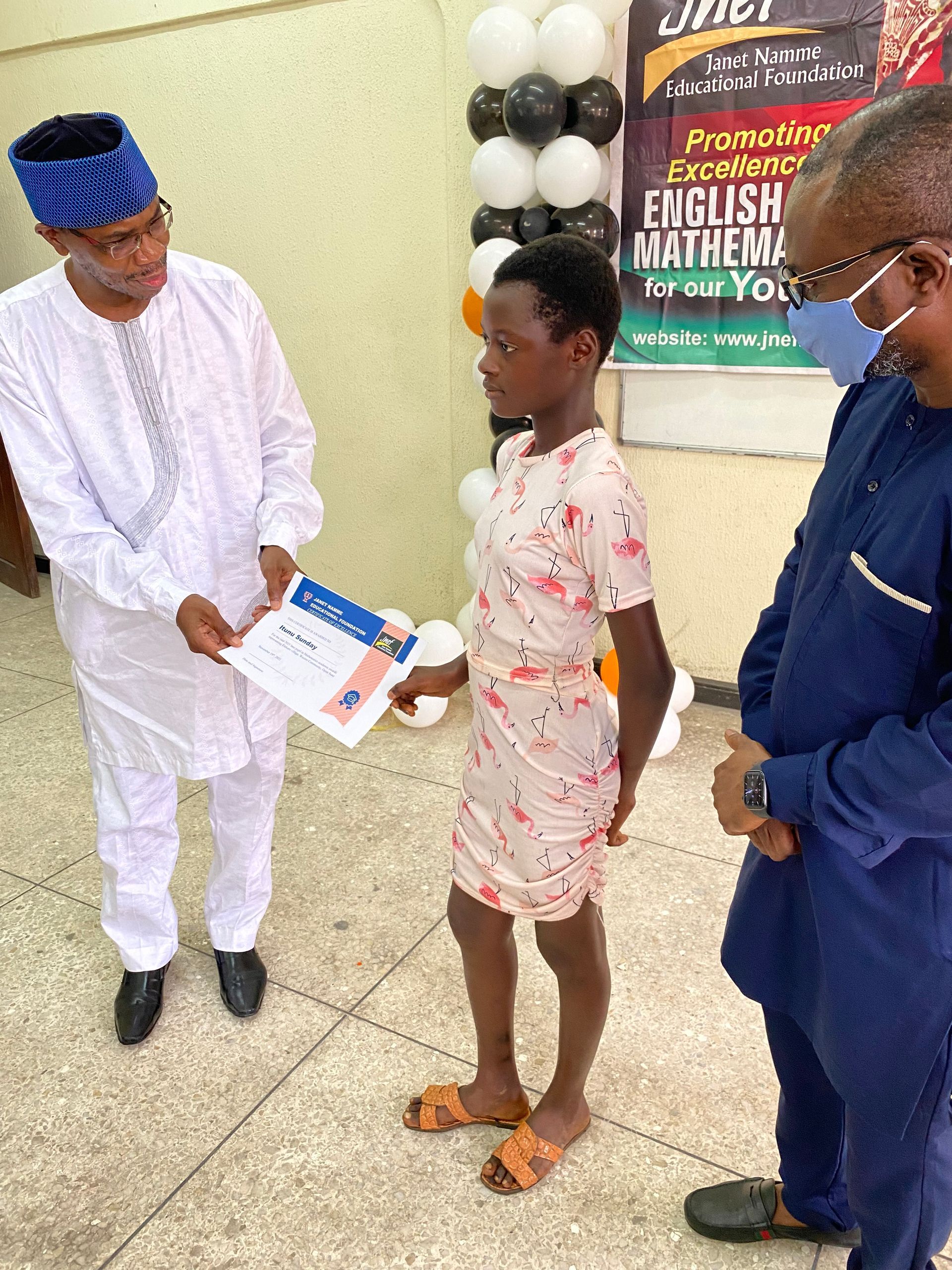 A man is giving a certificate to a young girl.