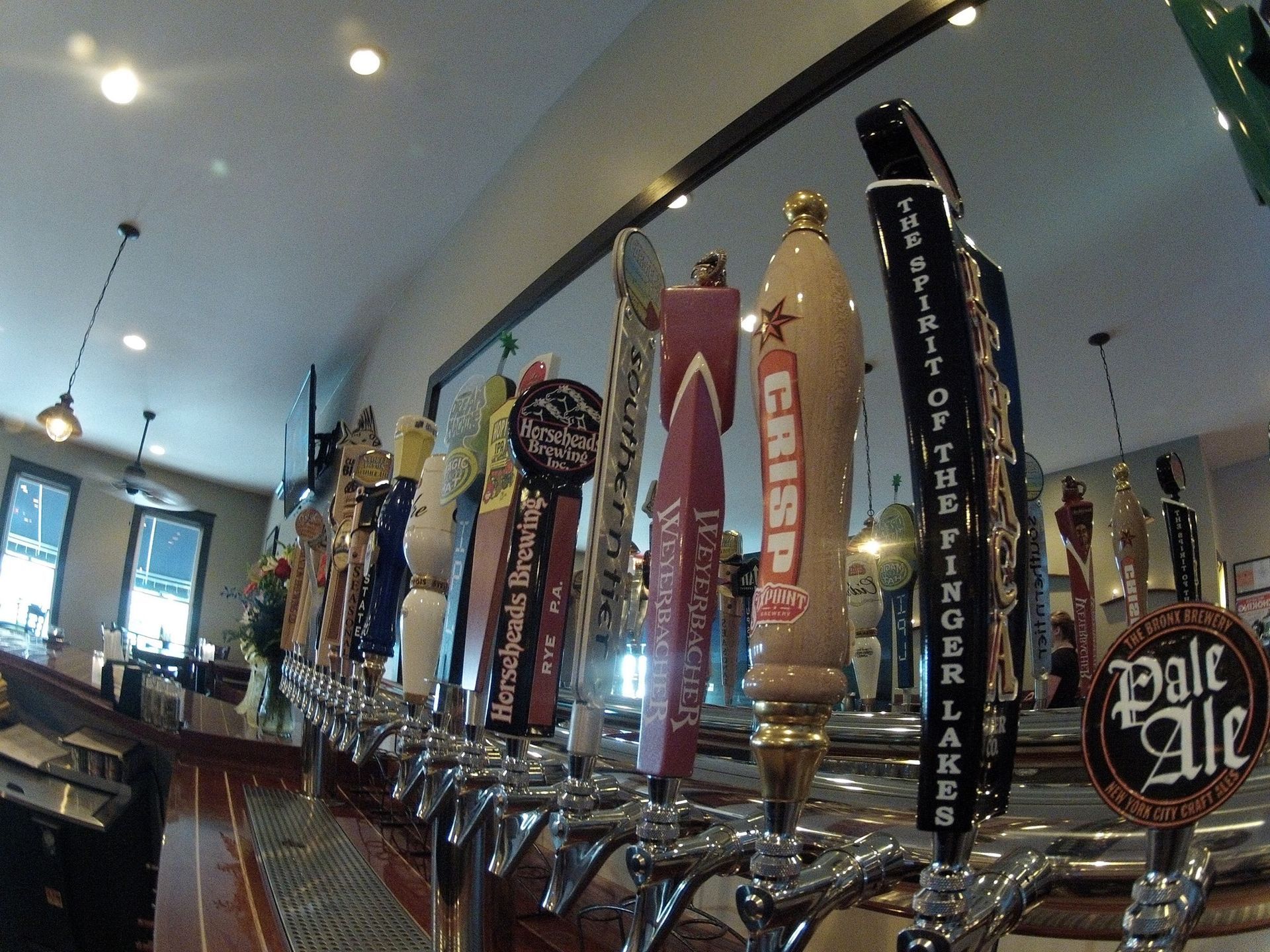 A row of beer taps with one that says pale ale