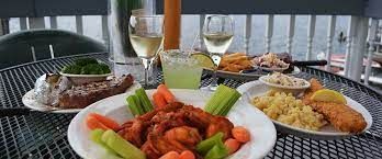 A table topped with plates of food and glasses of wine.