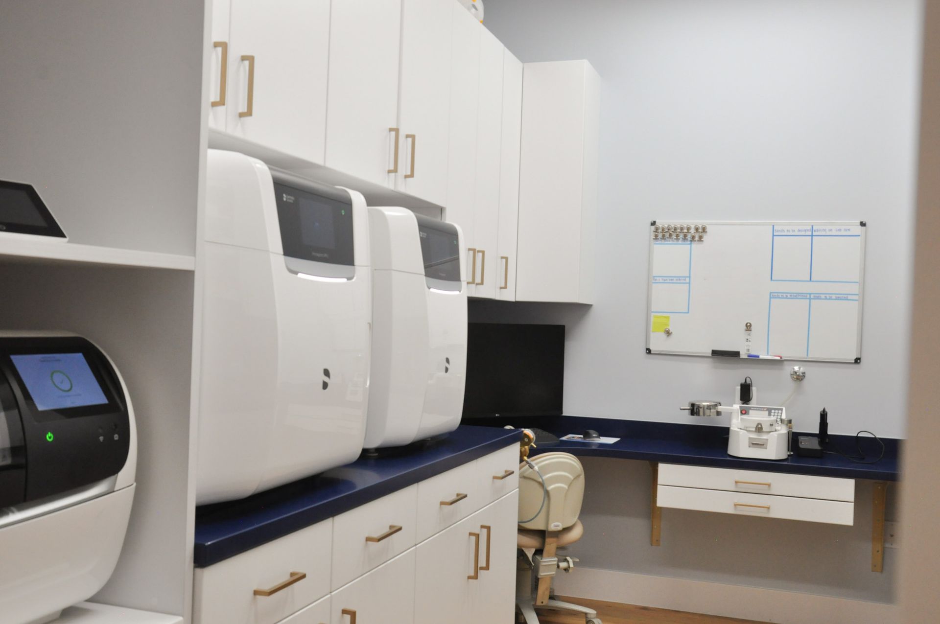 A laboratory with white cabinets, equipment, and a computer.