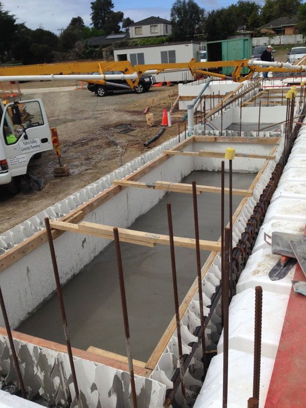 A construction site with a truck and a crane in the background