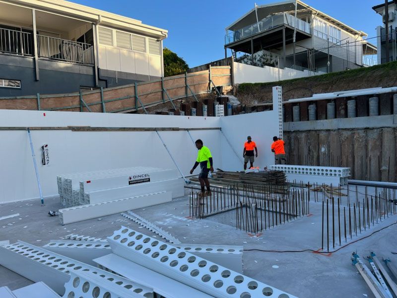 A group of construction workers are working on a building under construction.