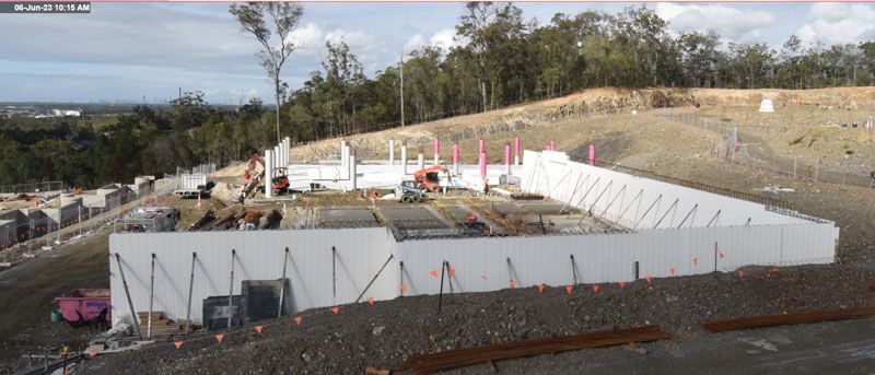 A large building is being built on top of a hill.