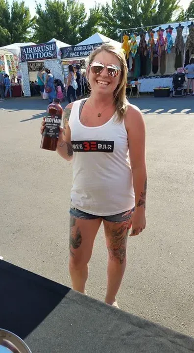 Woman Holding a Small Bottle of Bloody Mary Mix