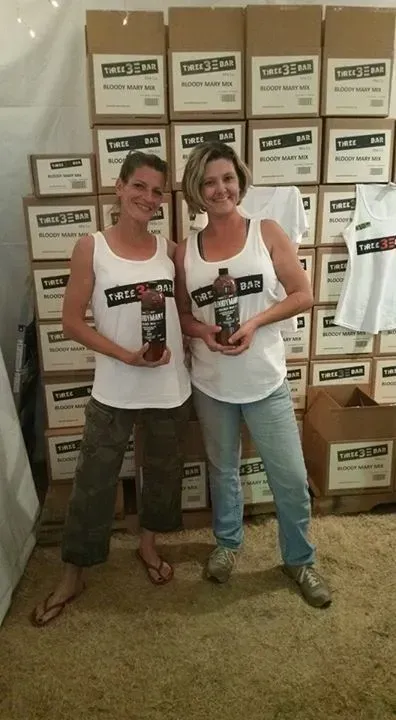 Women Holding a Bottle of Bloody Mary Mix