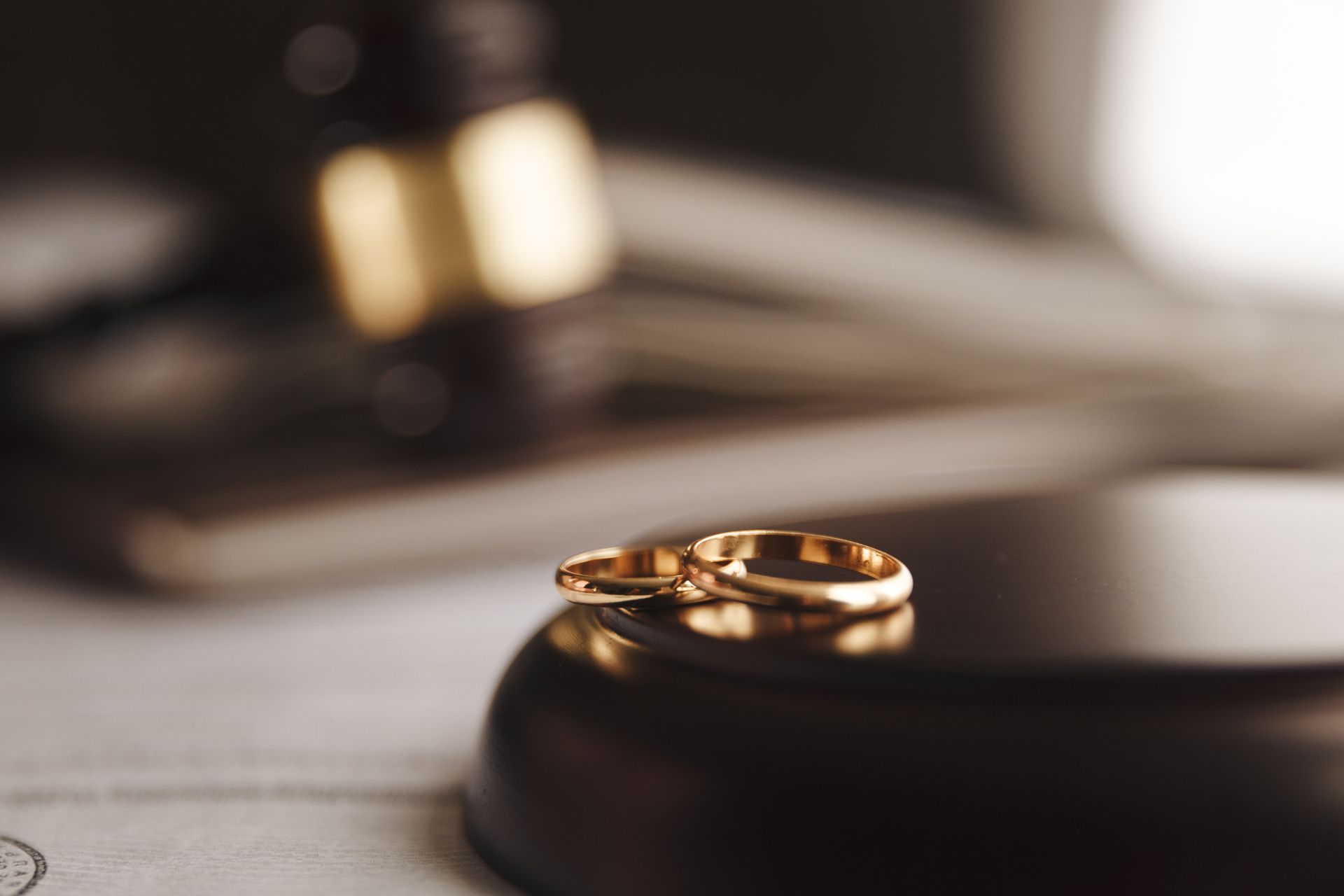 A pair of wedding rings are sitting on top of a piece of paper.