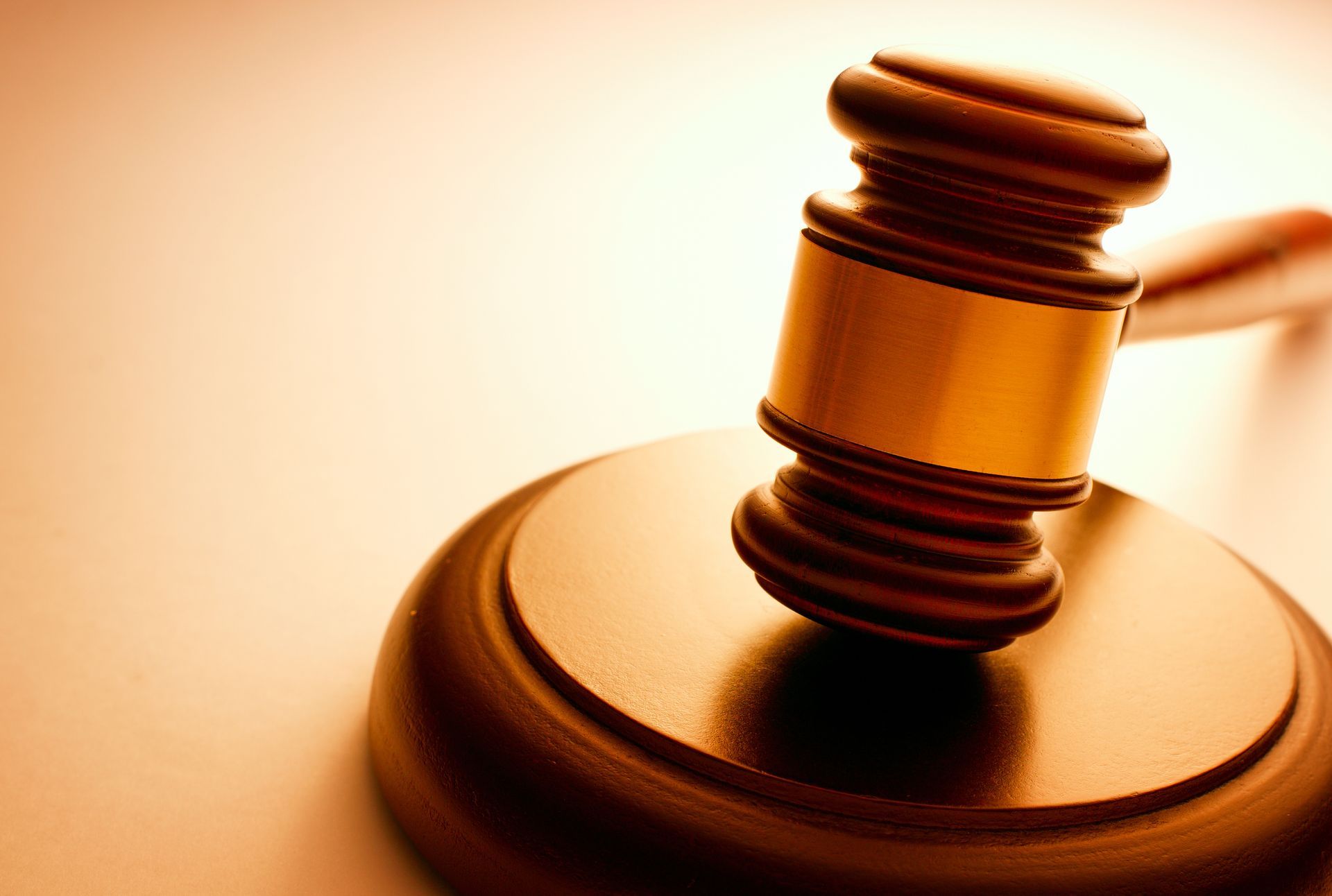 Wooden gavel on its block, lit with warm tones, representing litigation attorney in Los Angeles.