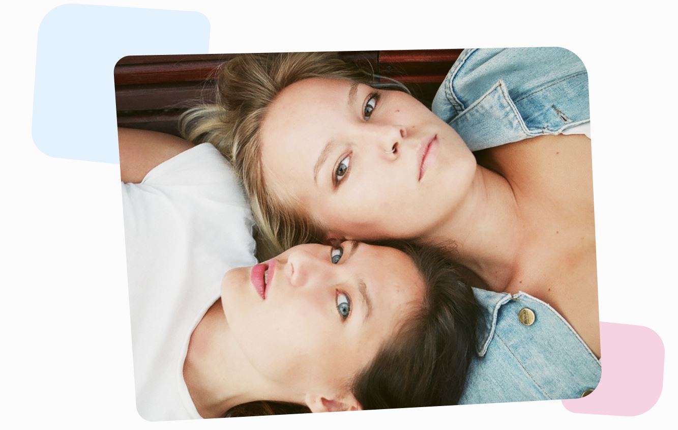 two young women lying together head to head