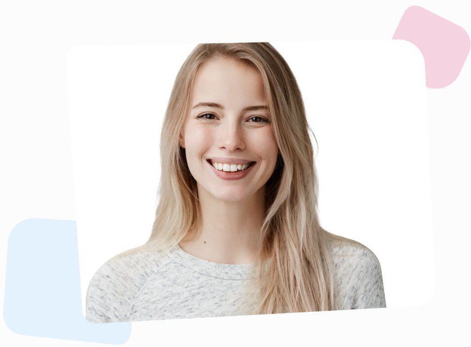 young blonde woman with long hair, smiling at the camera, wearing a grey blouse