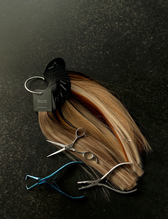 A bunch of hair and scissors on a table