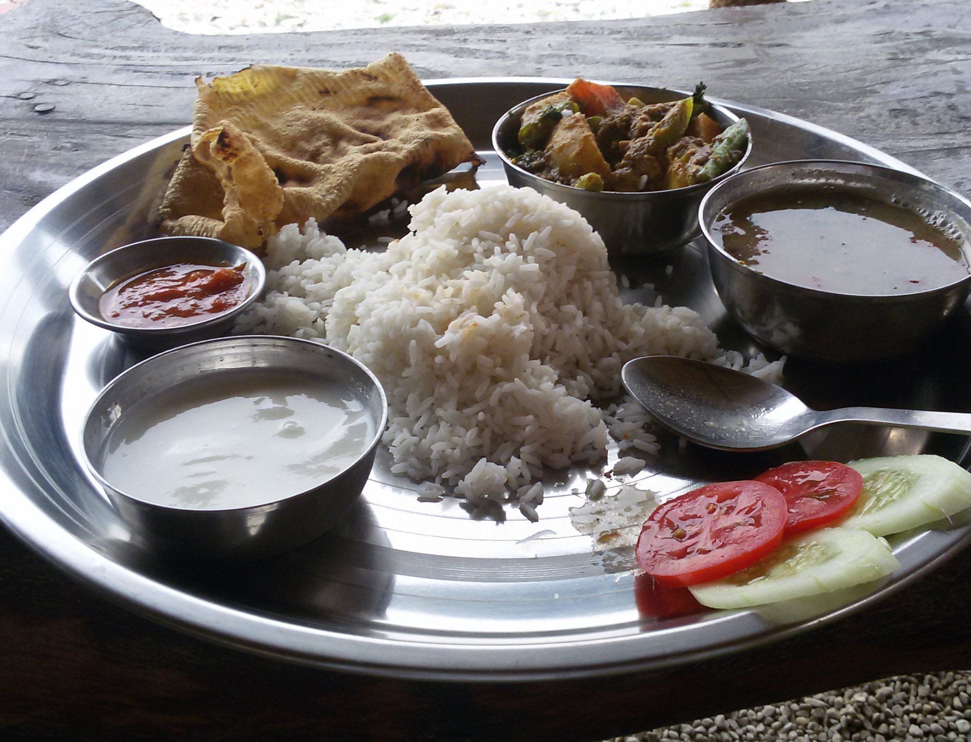Traditional dal bhat meal with rice and vegetables, a staple dish for trekkers in the Annapurna Range in Nepal.