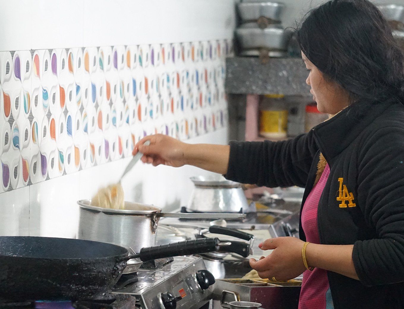 Local kitchen on the Annapurna Trek in Nepal, where a woman prepares traditional meals for hungry trekkers.