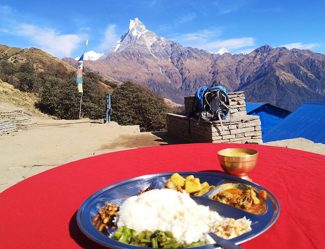 Breathtaking view from Mardi Himal Trek in Nepal, with local food enjoyed in a stunning mountain setting.