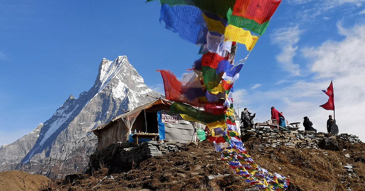 Colourful prayer flags with a peak in the background on the mardi Himal trek in Nepal