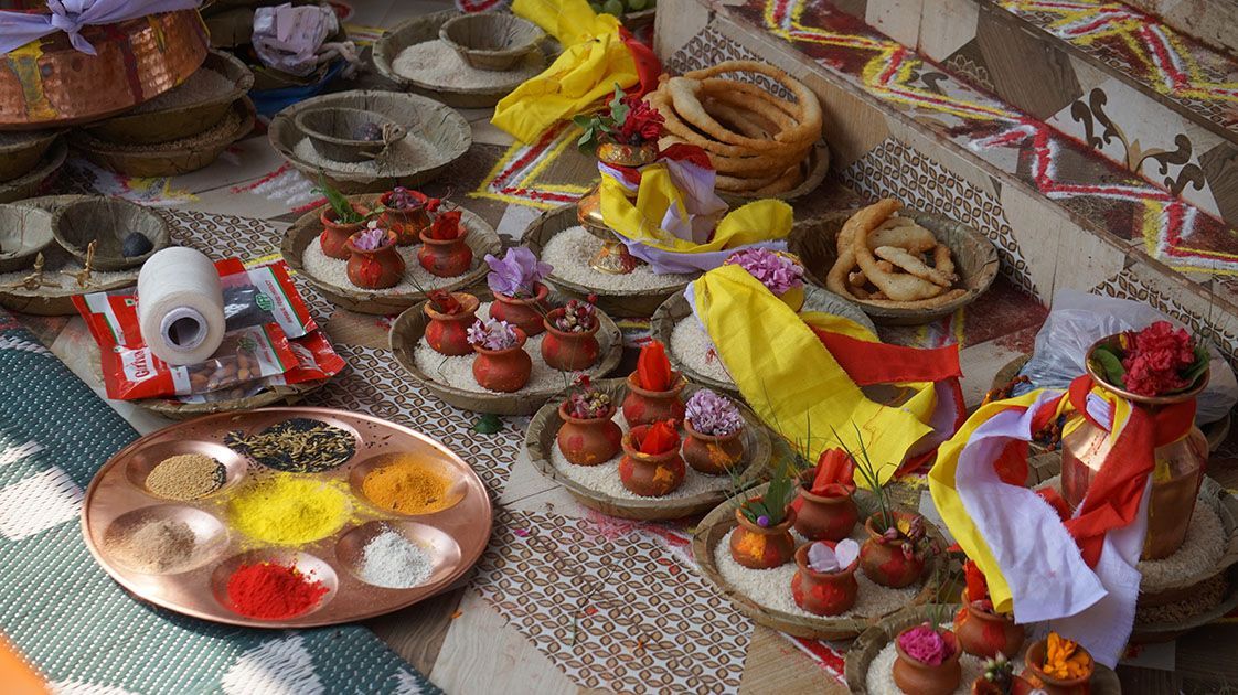 A lively Nepali celebration featuring a colorful array of traditional food served on a decorated table.
