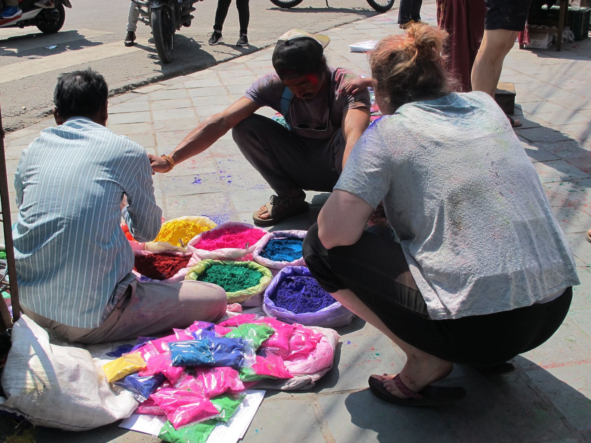 Local vendors selling colorful powders for Holi in Pokhara, Nepal, showcasing a variety of vibrant hues for the festival.