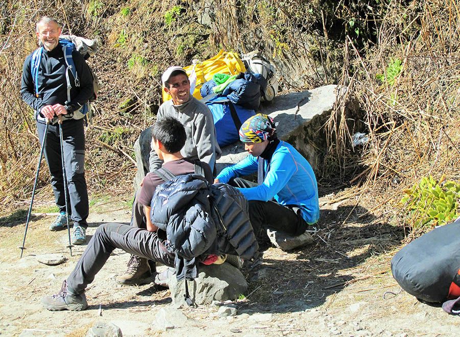 Trekkers with trekking guide and helper on trek in Nepal