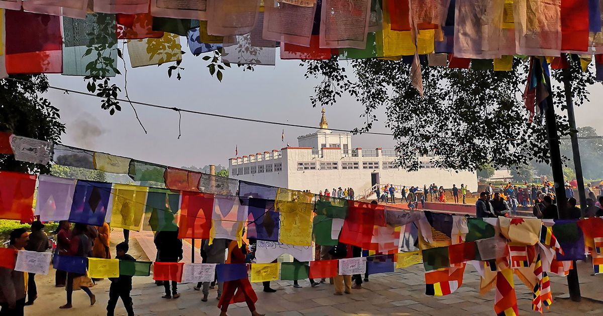 A panoramic view of Lumbini, showcasing beautiful gardens and the iconic Maya Devi Temple in the background.