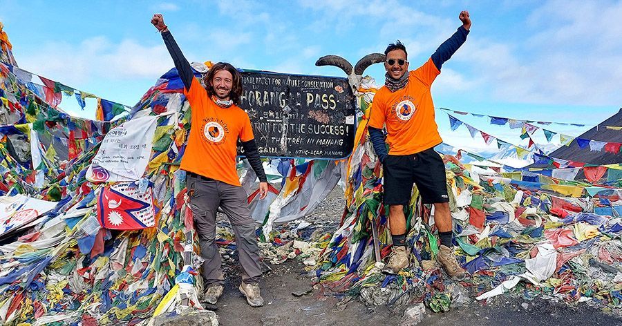 Local guide with a trekker at Thorong La Pass in Nepal