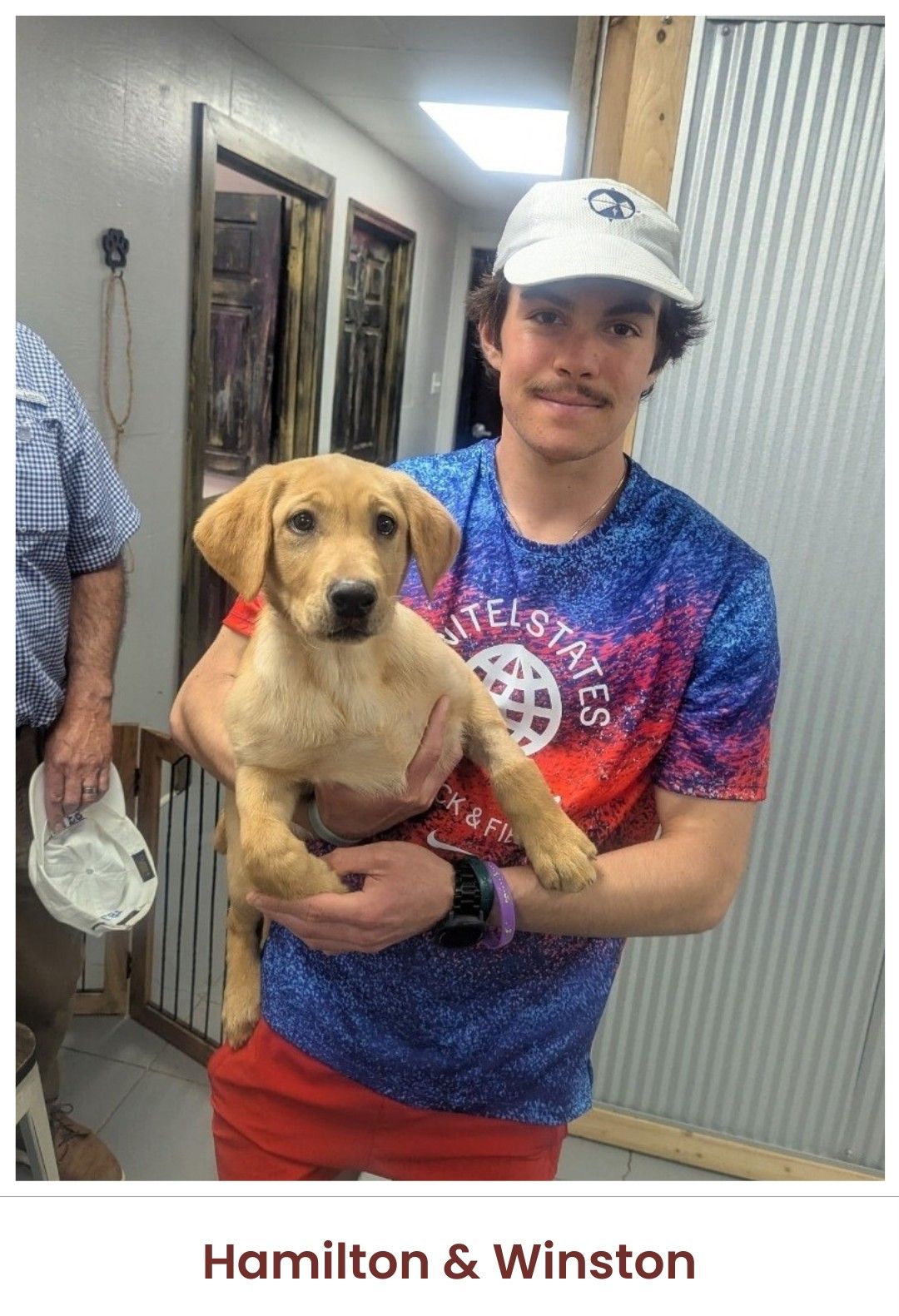 A person wearing a patterned shirt and cap holds a light-brown puppy indoors. Text below reads: "Hamilton & Winston".