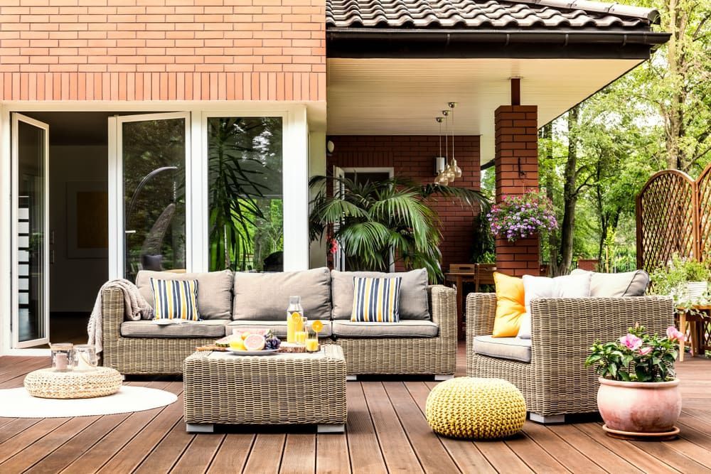 Outdoor Patio With Wicker Furniture, Tan Cushions, and Brick Accents — Kalora Carpentry & Restorations in New Lambton, NSW