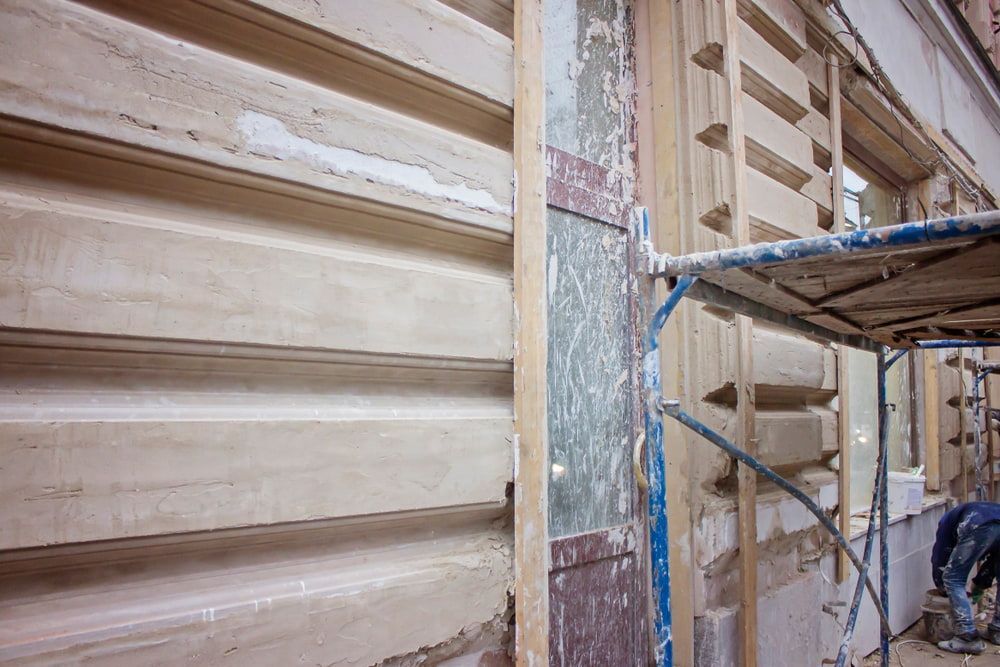 Close-up of Building Exterior With Scaffolding and Workers — Kalora Carpentry & Restorations in Charlestown, NSW