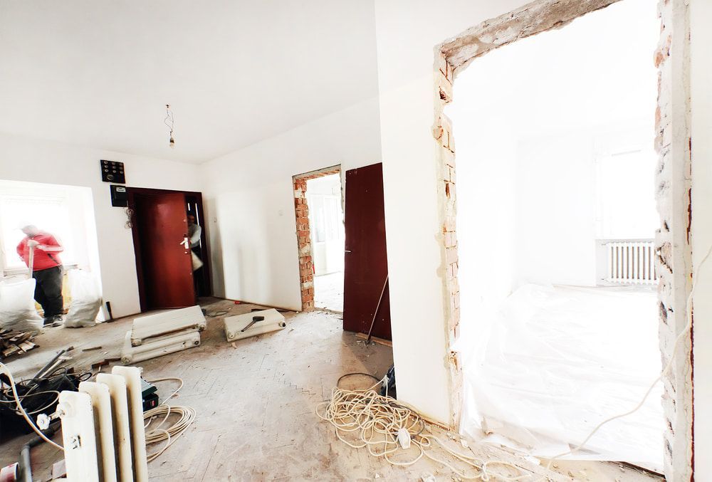 Interior of a Room Under Renovation With Exposed Brick, Debris — Kalora Carpentry & Restorations in Charlestown, NSW
