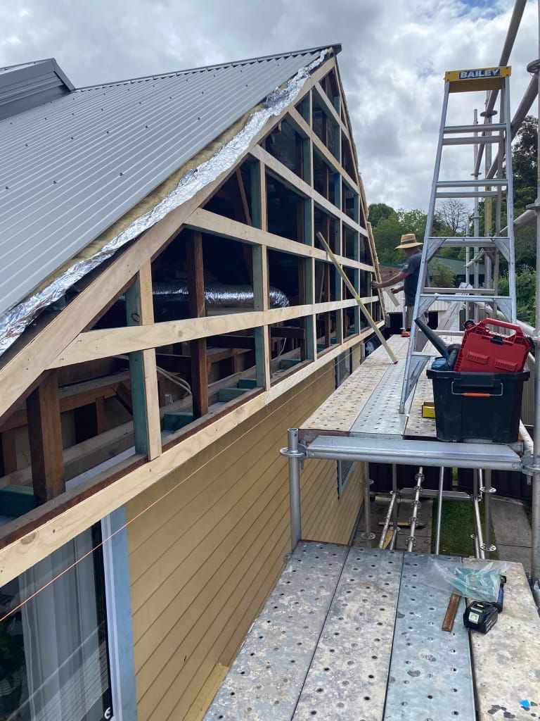 Construction Work on a House's Exterior. Scaffolding Supports a Worker — Kalora Carpentry & Restorations in Charlestown, NSW