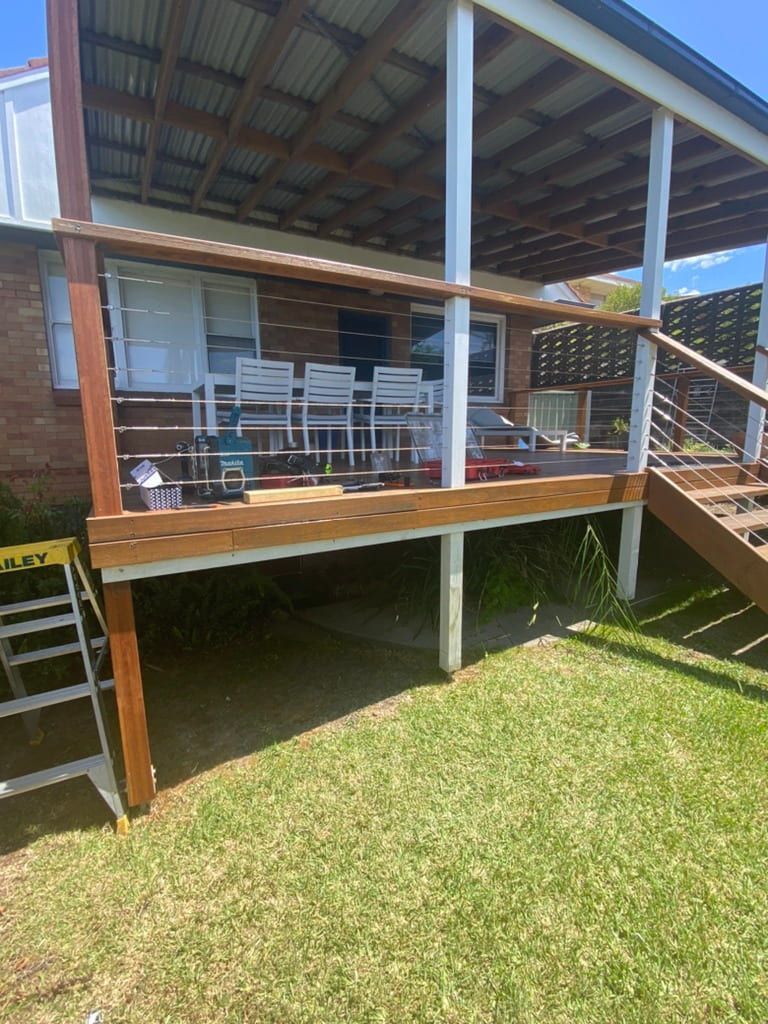 Wooden Deck With Chairs and Table, Overlooking a Grassy Backyard — Kalora Carpentry & Restorations in Merewether, NSW