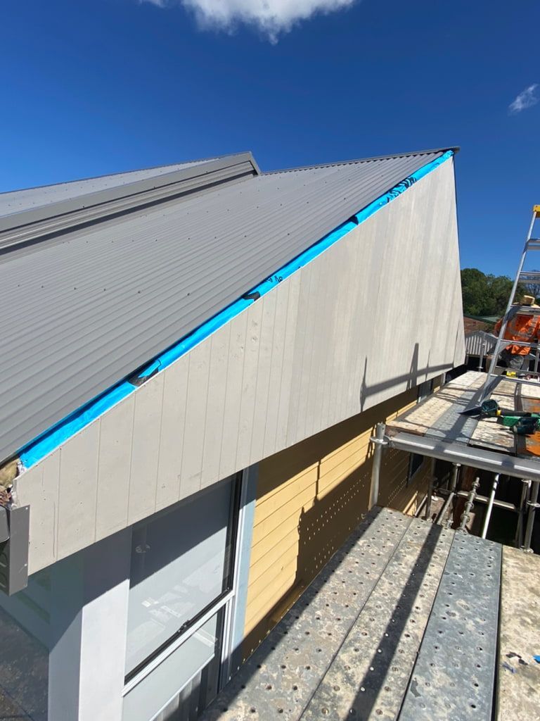 Construction Site: Gray Roof, Beige Wall, Yellow Siding, Scaffolding — Kalora Carpentry & Restorations in Charlestown, NSW