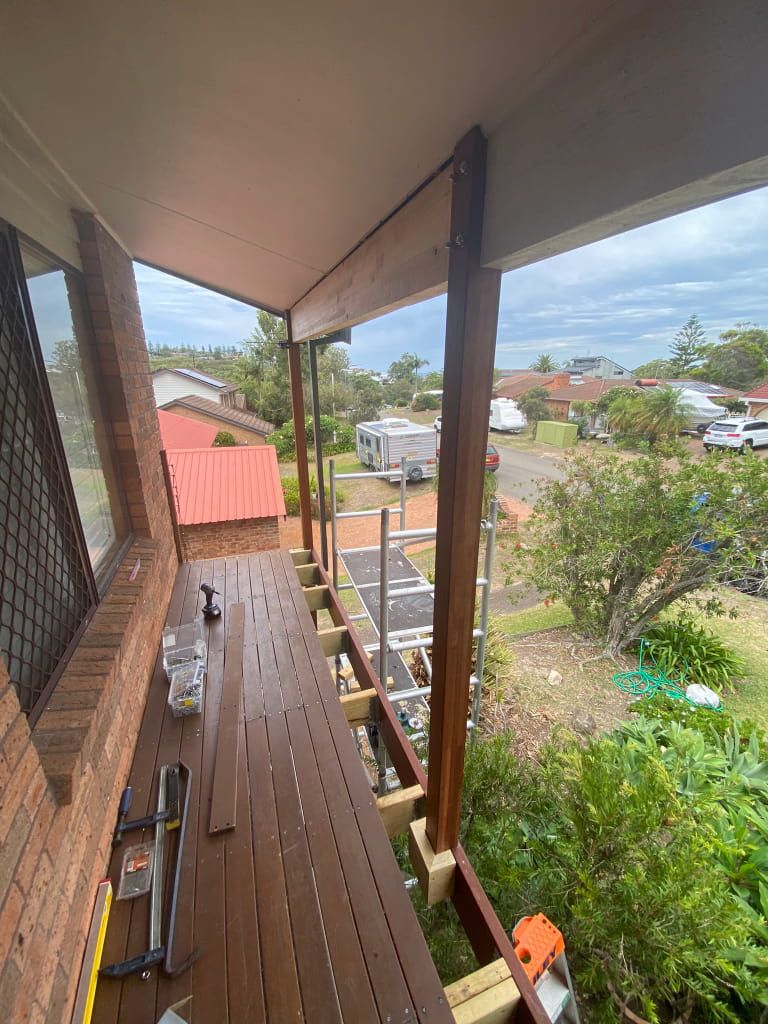 Deck Under Construction; Dark Brown Decking Boards — Kalora Carpentry & Restorations in New Lambton, NSW
