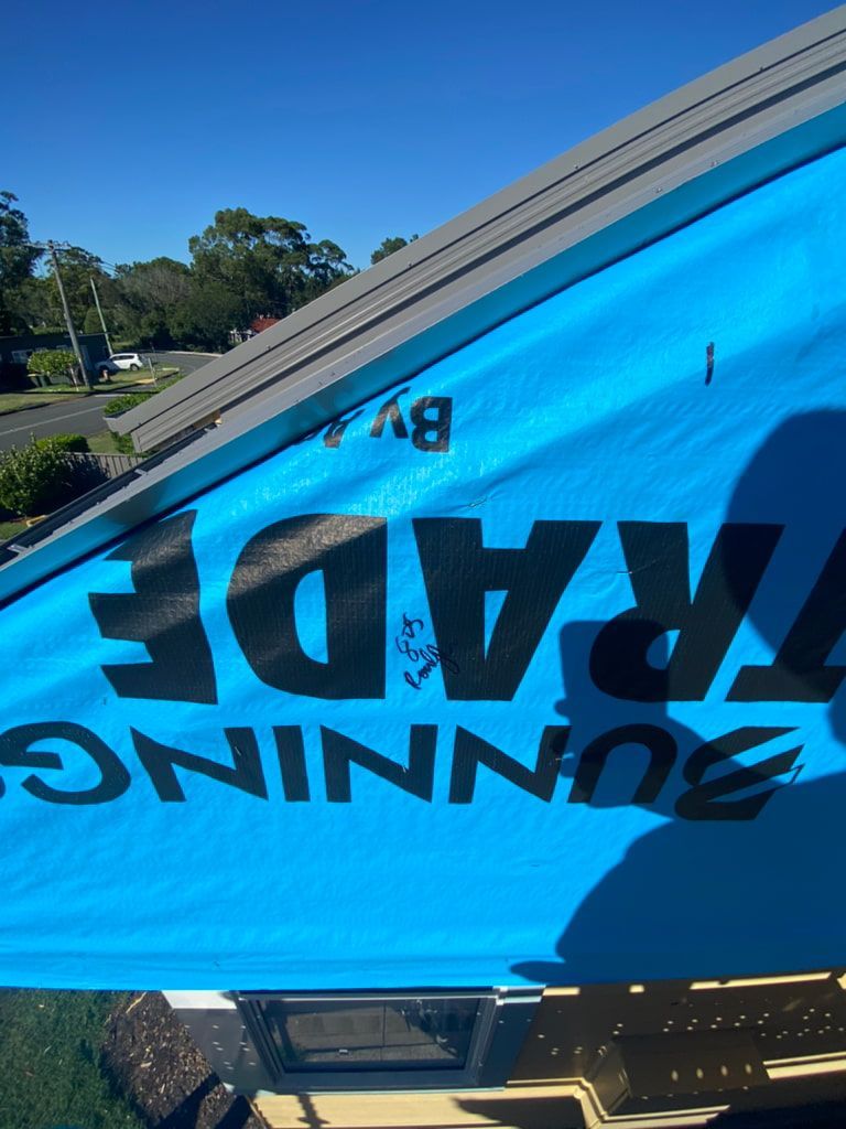 Blue Building Wrap — Kalora Carpentry & Restorations in Charlestown, NSW