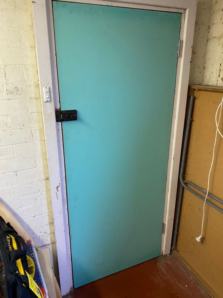 Aqua Blue Door With Black Latch and White Frame — Kalora Carpentry & Restorations in Charlestown, NSW