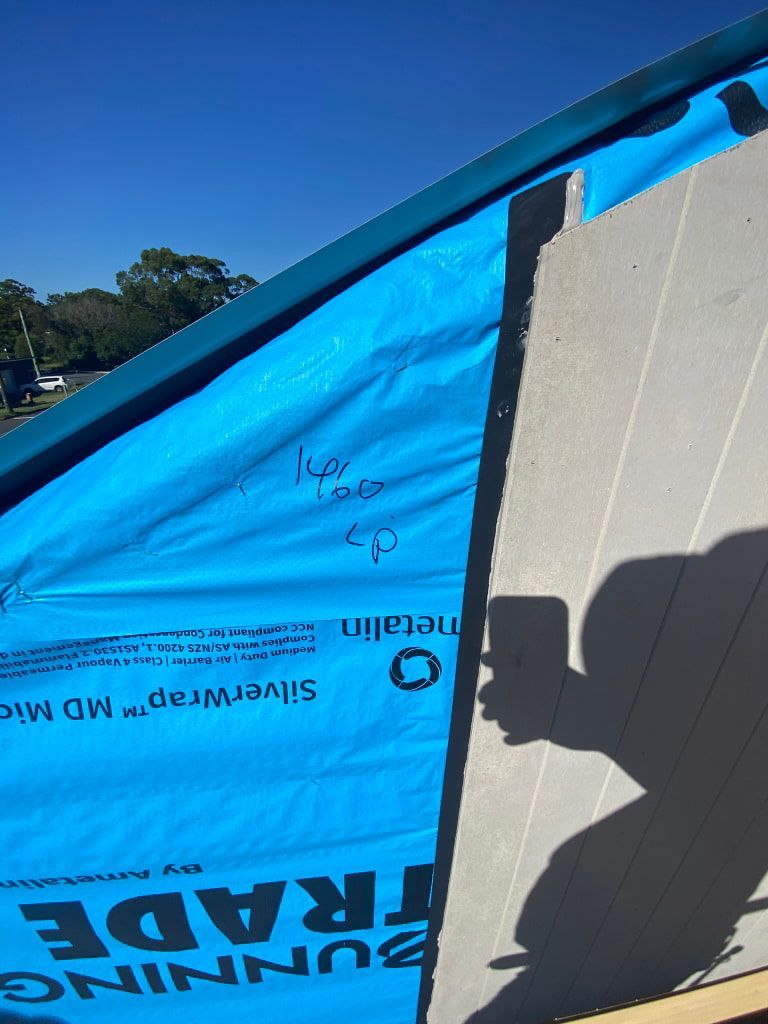 Blue Roofing Underlayment on a Roof, Showing a Person's Shadow — Kalora Carpentry & Restorations in Charlestown, NSW