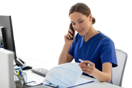 A nurse is talking on a cell phone while looking at a clipboard.
