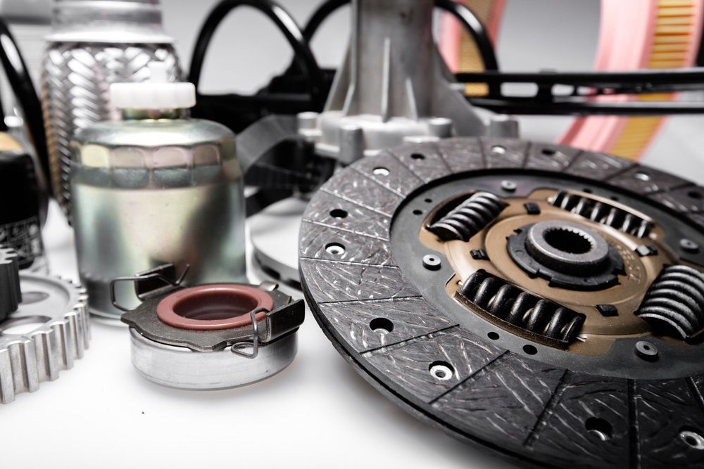 A Close Up Of A Clutch Disc And Other Car Parts On A Table — Crossway Wreckers & Mechanical In Cairns, QLD
