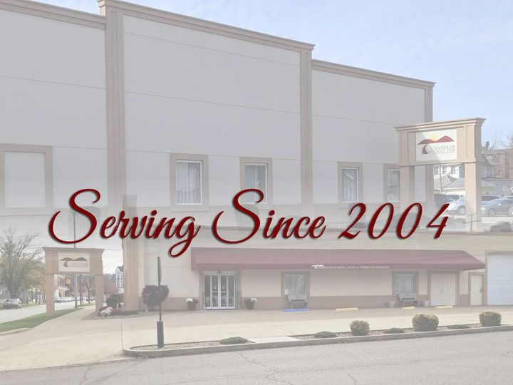 A fountain in a park with palm trees in the background