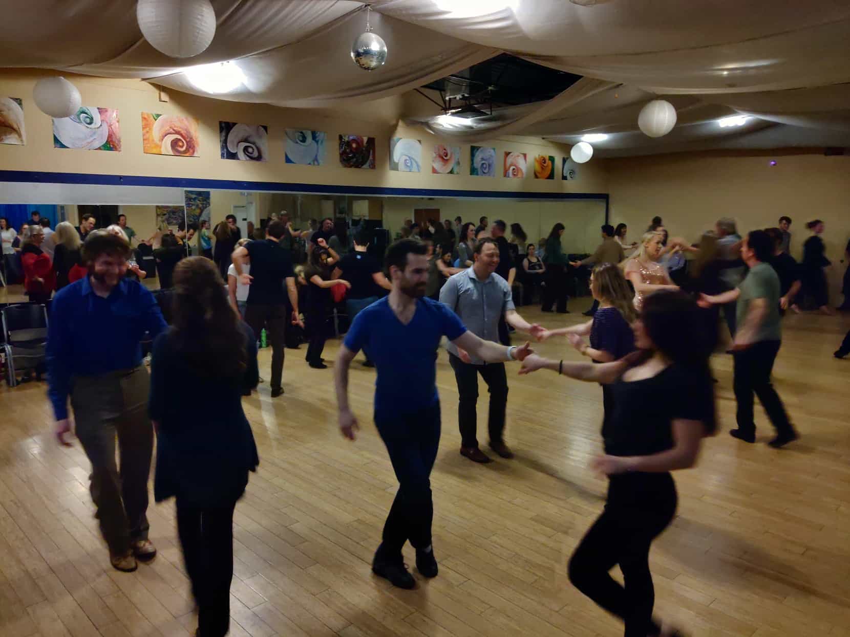 People swing dancing at a West Coast Swing event