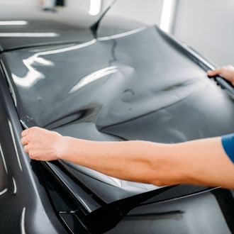 Window Tinting — Man Putting A Tint On A Car in Glen Burnie, MD