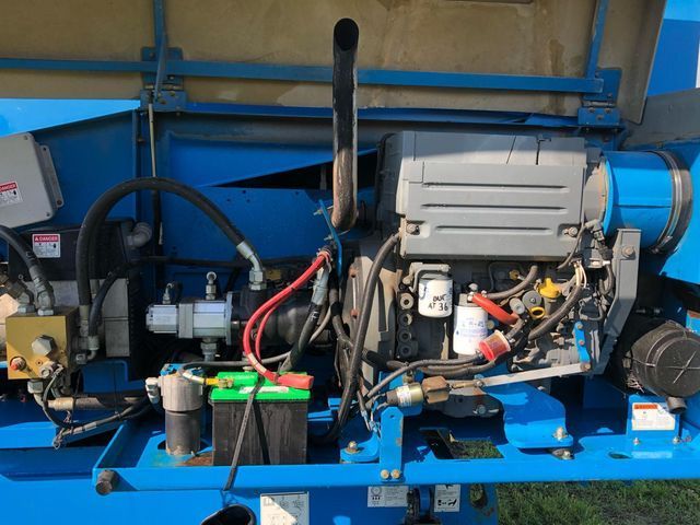 The inside of a blue machine with a green battery