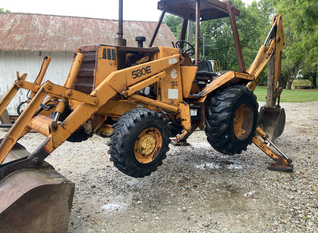 A yellow tractor with the number 5806 on it