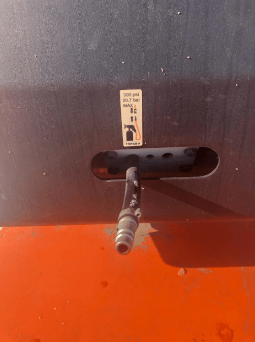 A hose is attached to the side of a vehicle