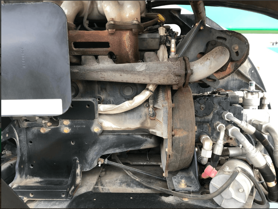 A close up of a car engine with a lot of wires coming out of it.