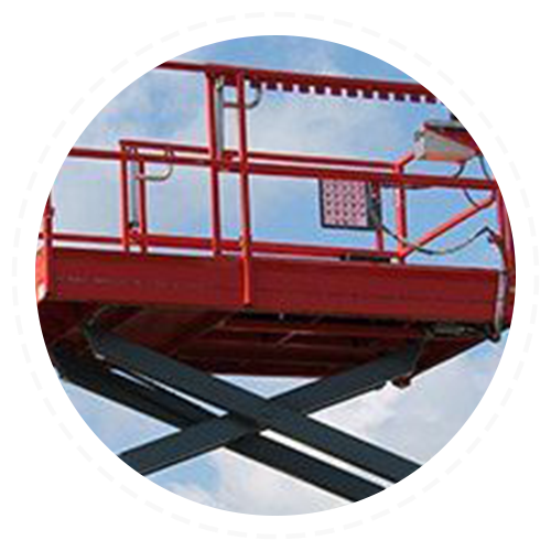 A red scissor lift with a railing against a blue sky.