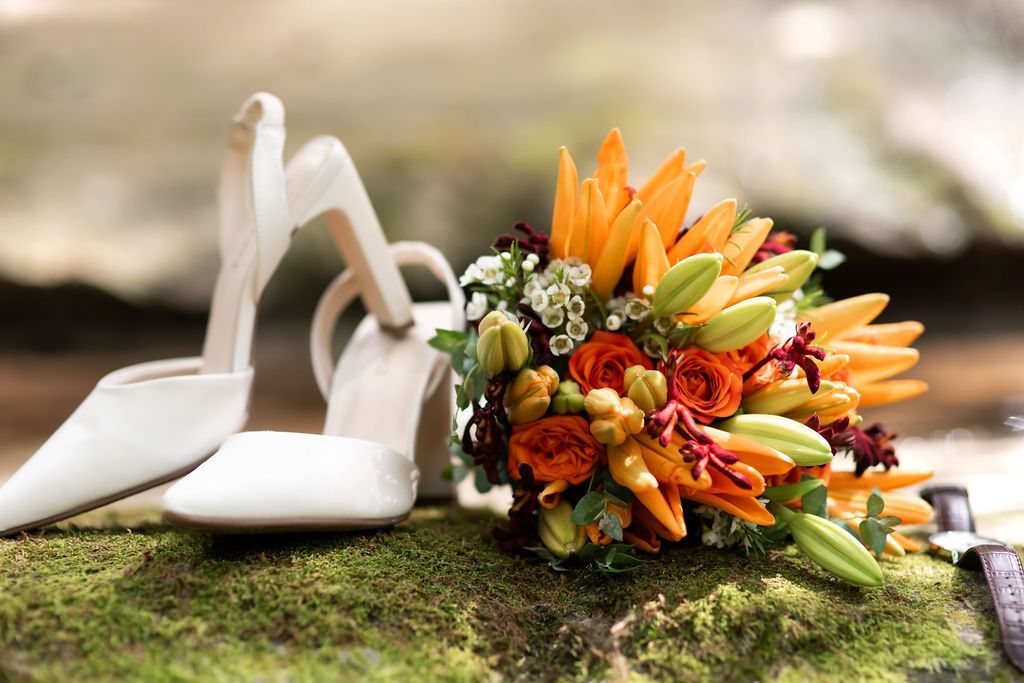 Wedding bouquet and heels on a mossy rock Wedding bouquet and heels on a mossy rock