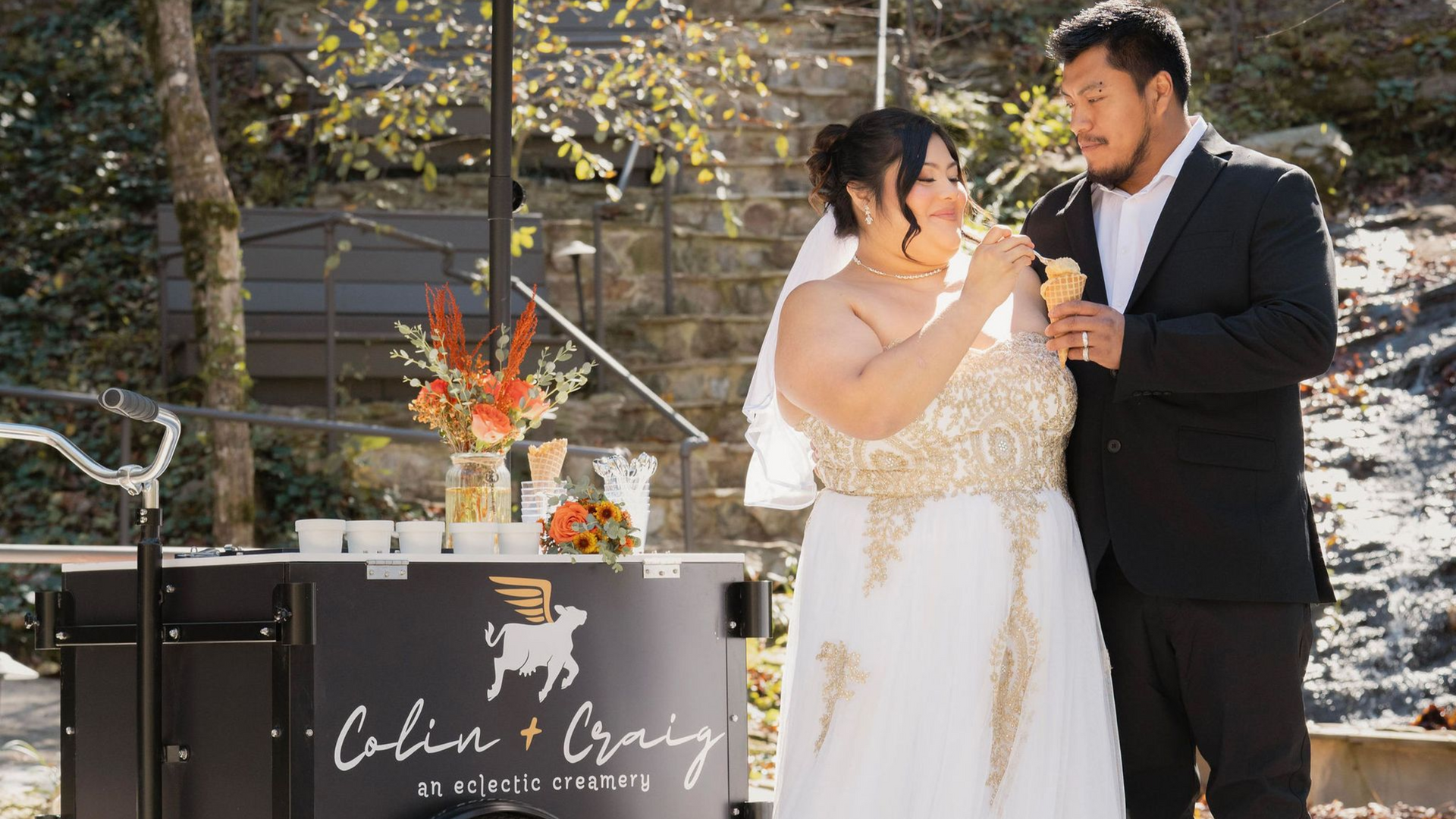 couple at their wedding with their ice cream car