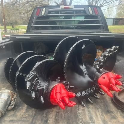 Two drill bits are sitting in the back of a truck.