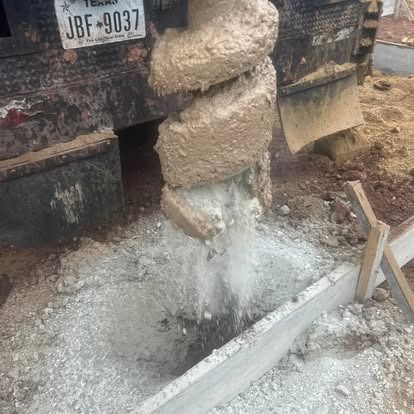 A concrete drill is being used to drill a hole in the ground.
